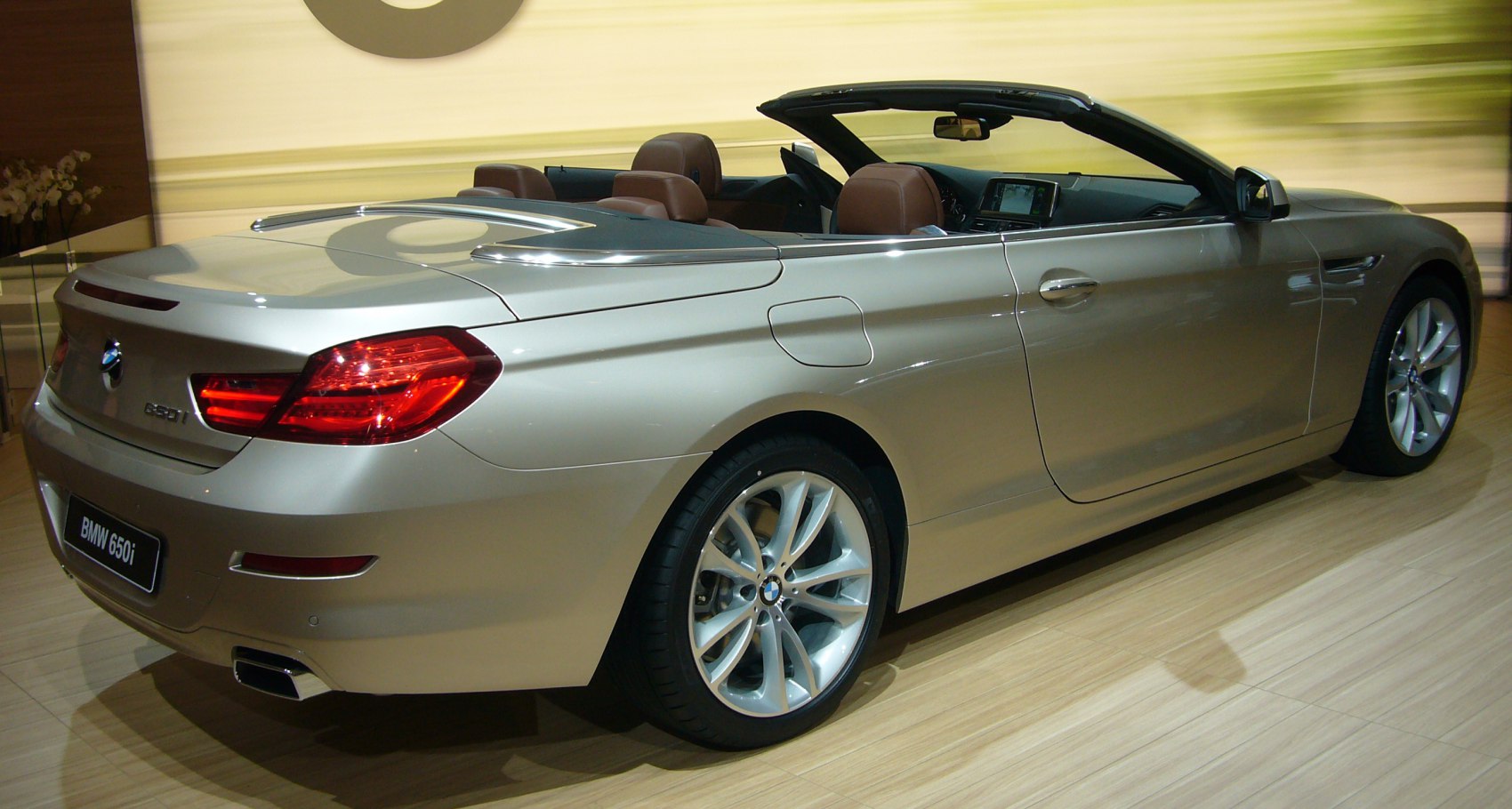 Rear and side view of convertible with open roof and alloy wheels