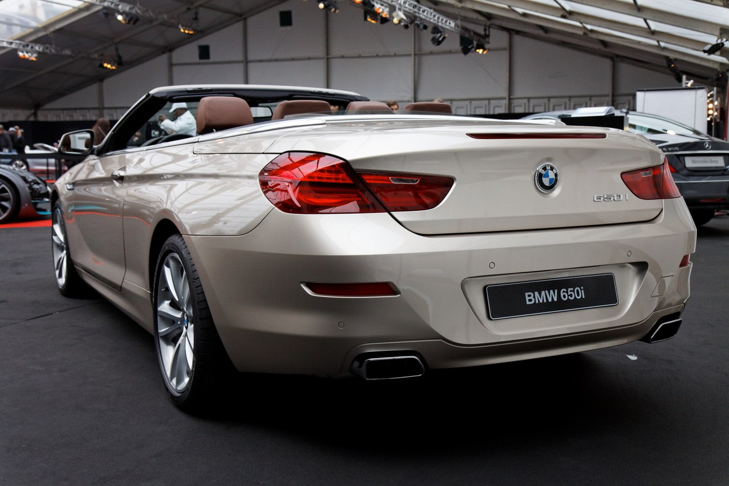 Rear view of luxury convertible with dual exhausts and distinctive tail lights