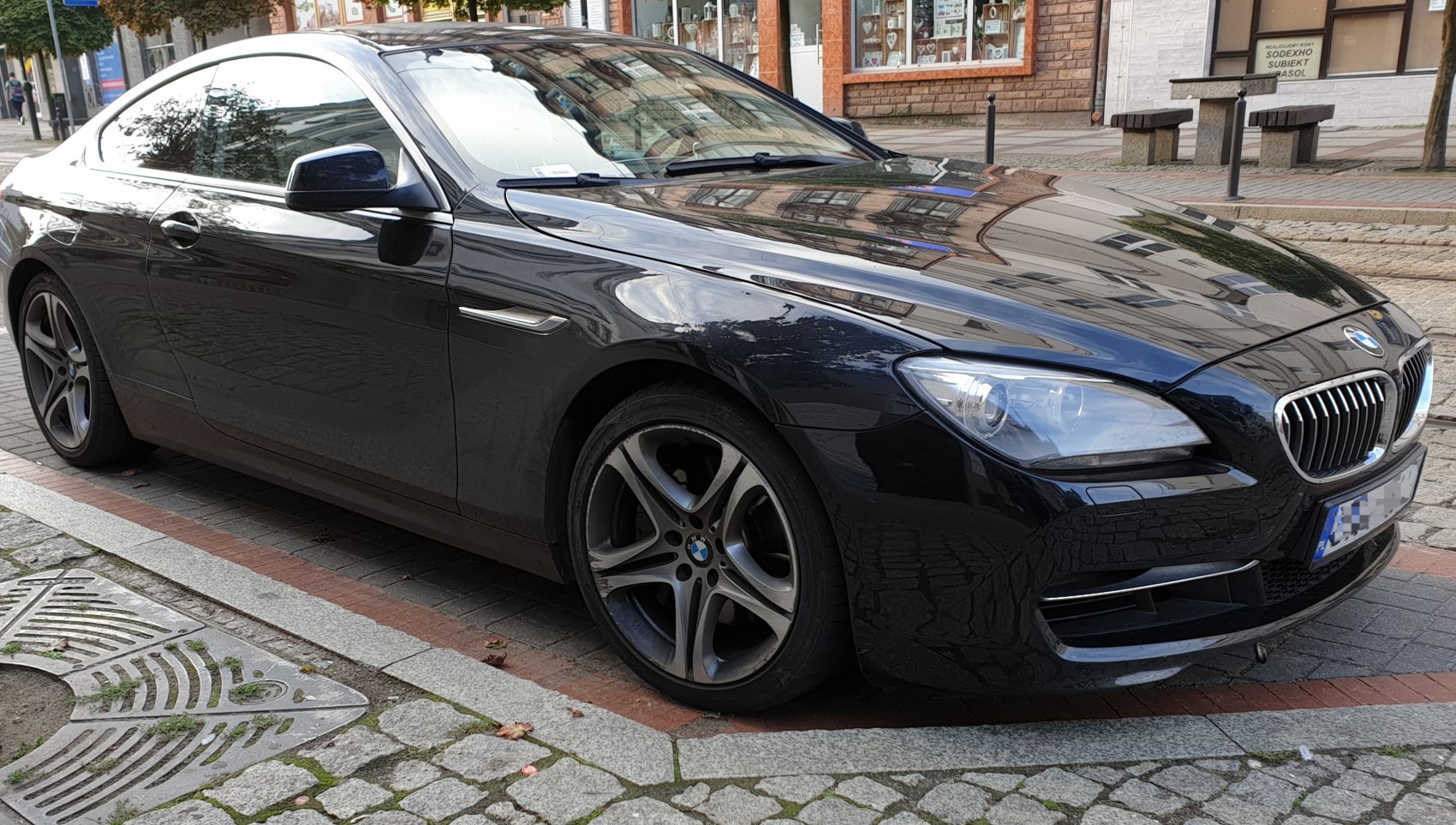 Sleek front side view of a black coupe with alloy wheels