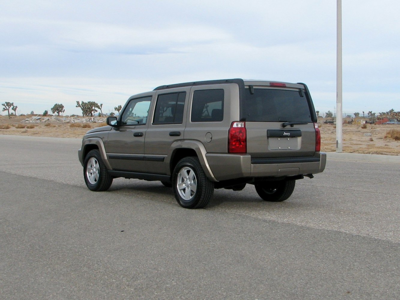 Rear three-quarter view of a boxy SUV with tinted windows and alloy wheels