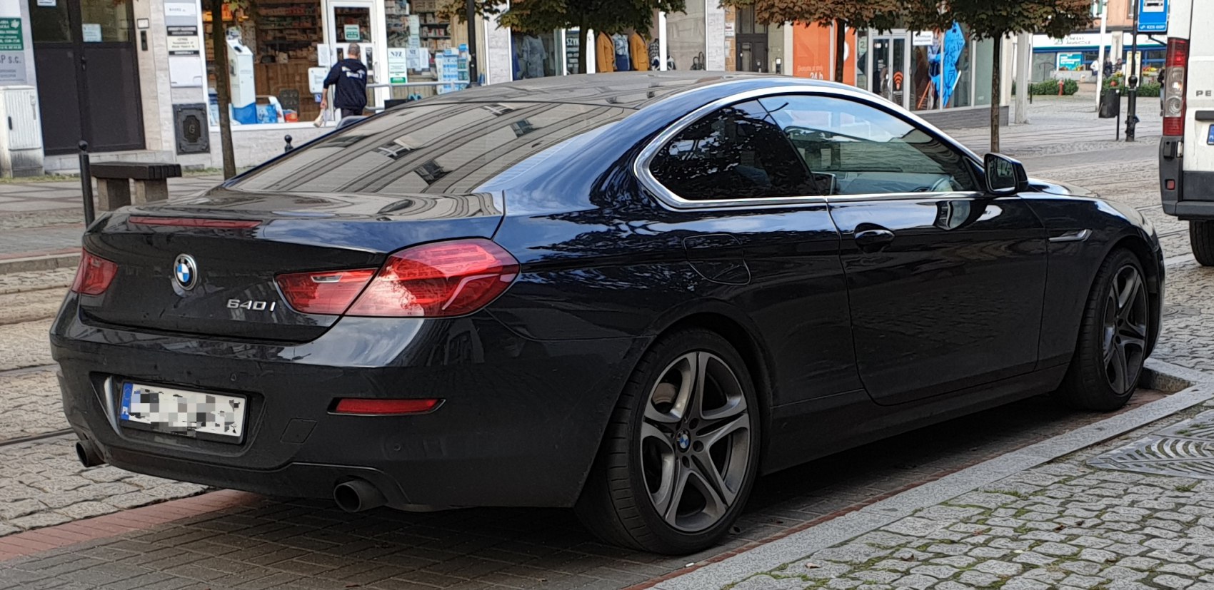Rear-side view of sleek coupe with alloy wheels and tinted windows