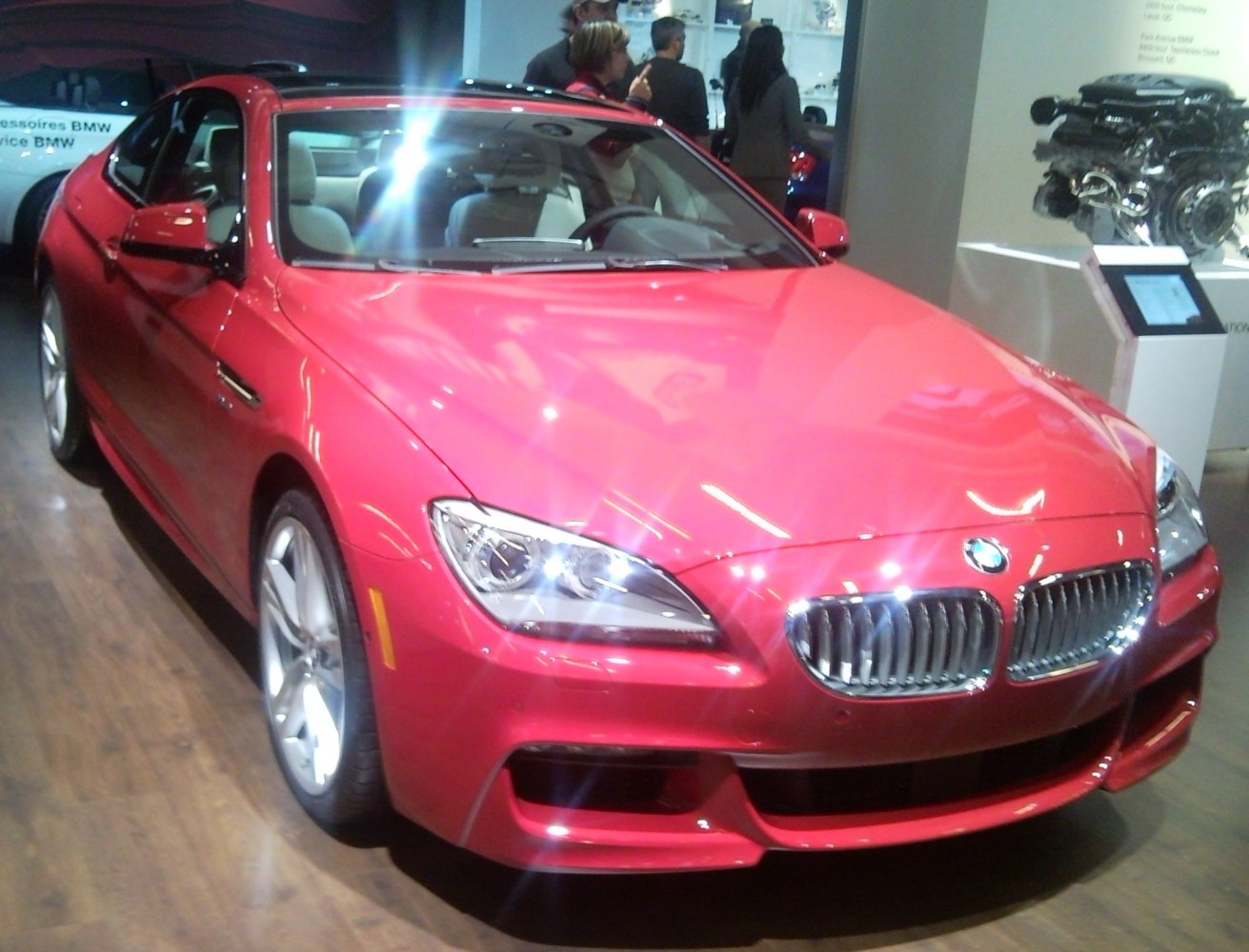 Front angle of red luxury coupe with distinctive grille and headlights
