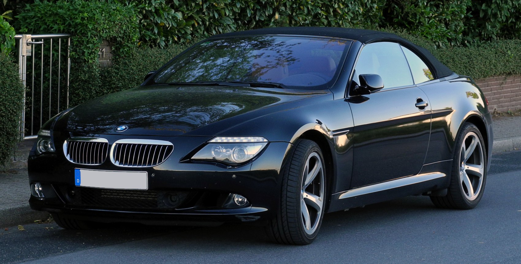 Front-side view of a convertible with LED headlights and soft top roof