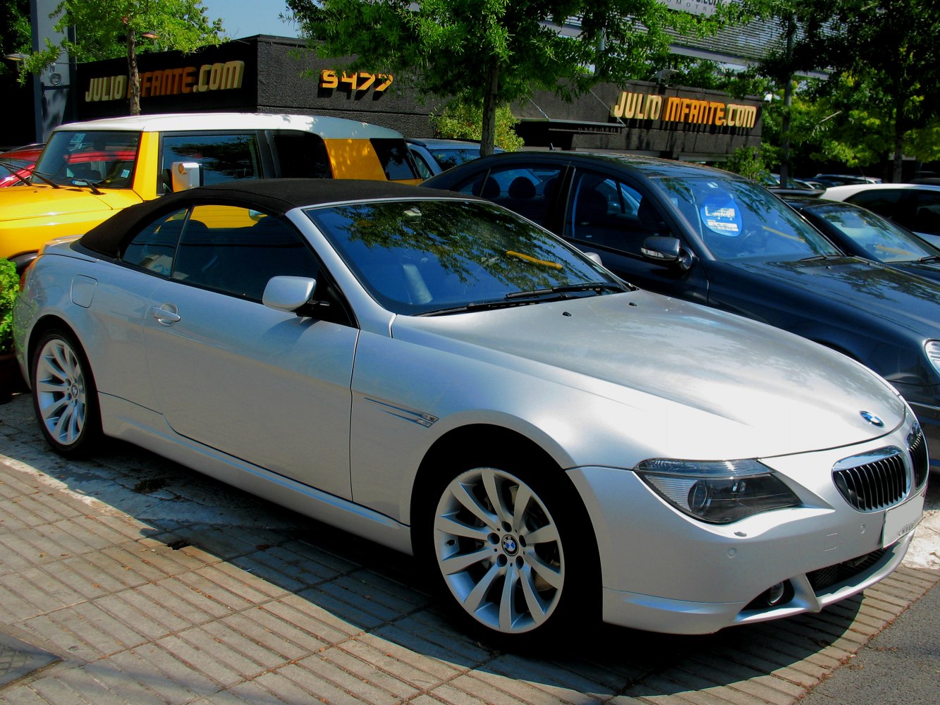 Silver convertible with black soft top and alloy wheels