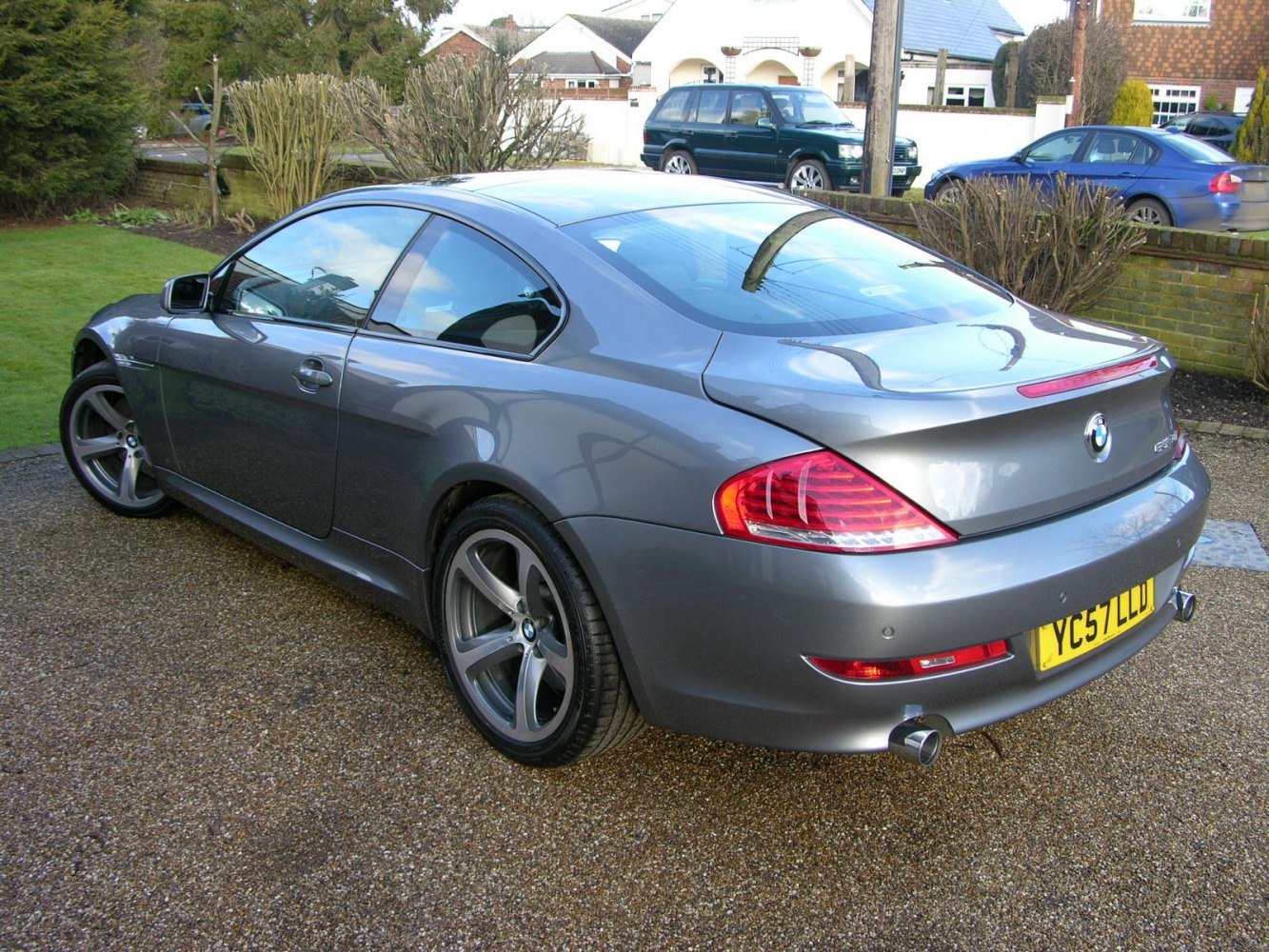 Gray coupe with distinctive taillights and dual exhaust pipes