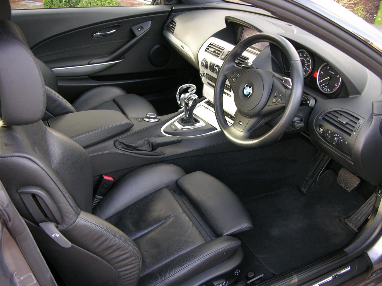 Luxury interior with leather seats, steering wheel, and central console