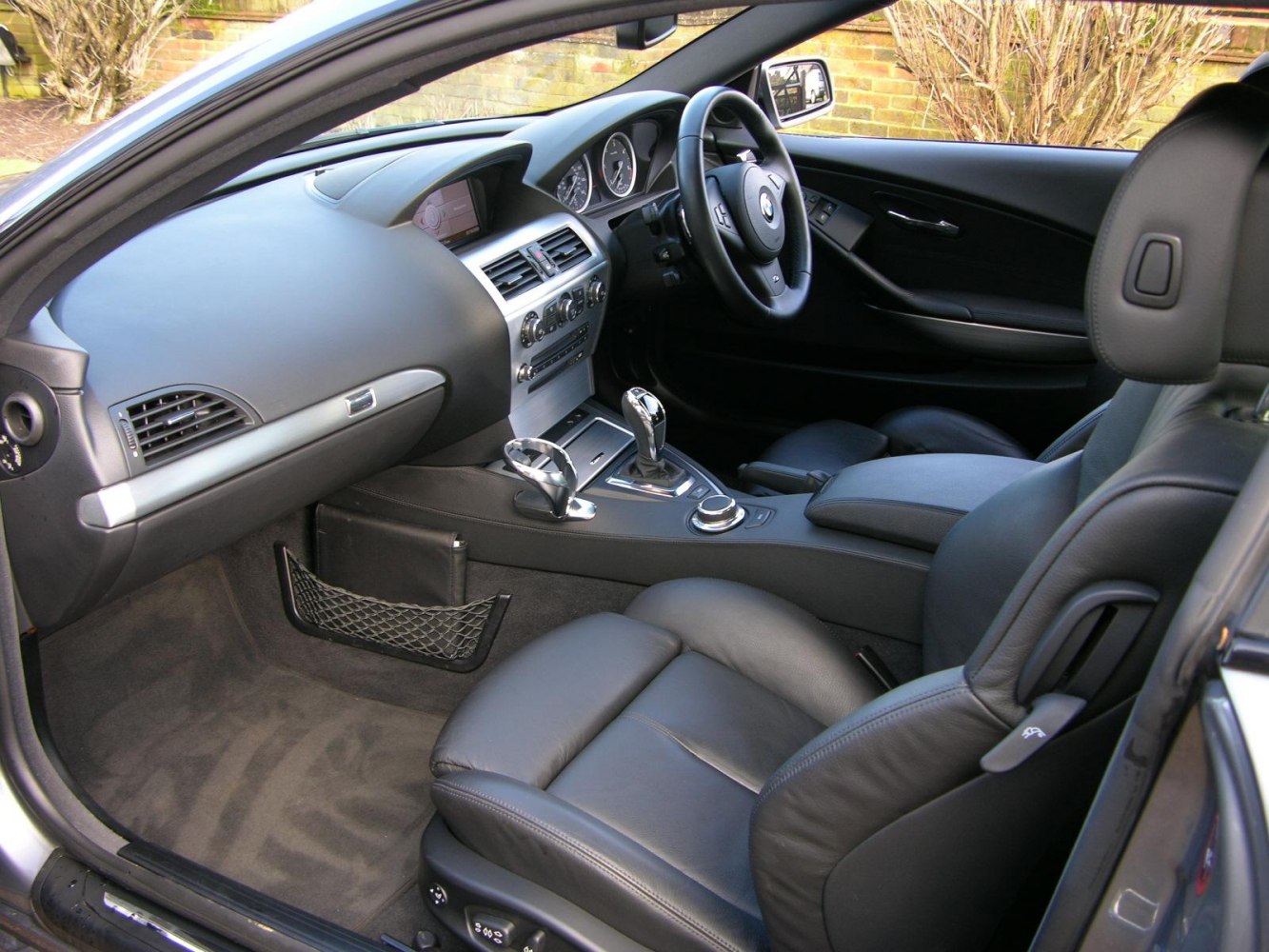 Dashboard, steering wheel, center console, and leather seats interior view