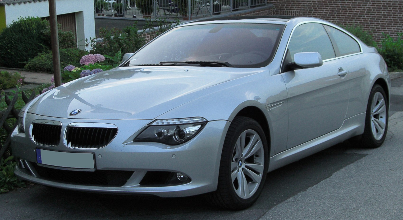 Silver coupe with distinct front grille and sleek headlights
