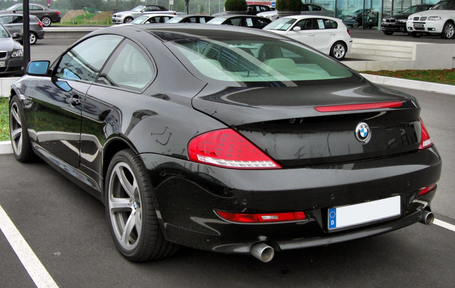 Rear view of sleek coupe with sporty tail lights and dual exhaust