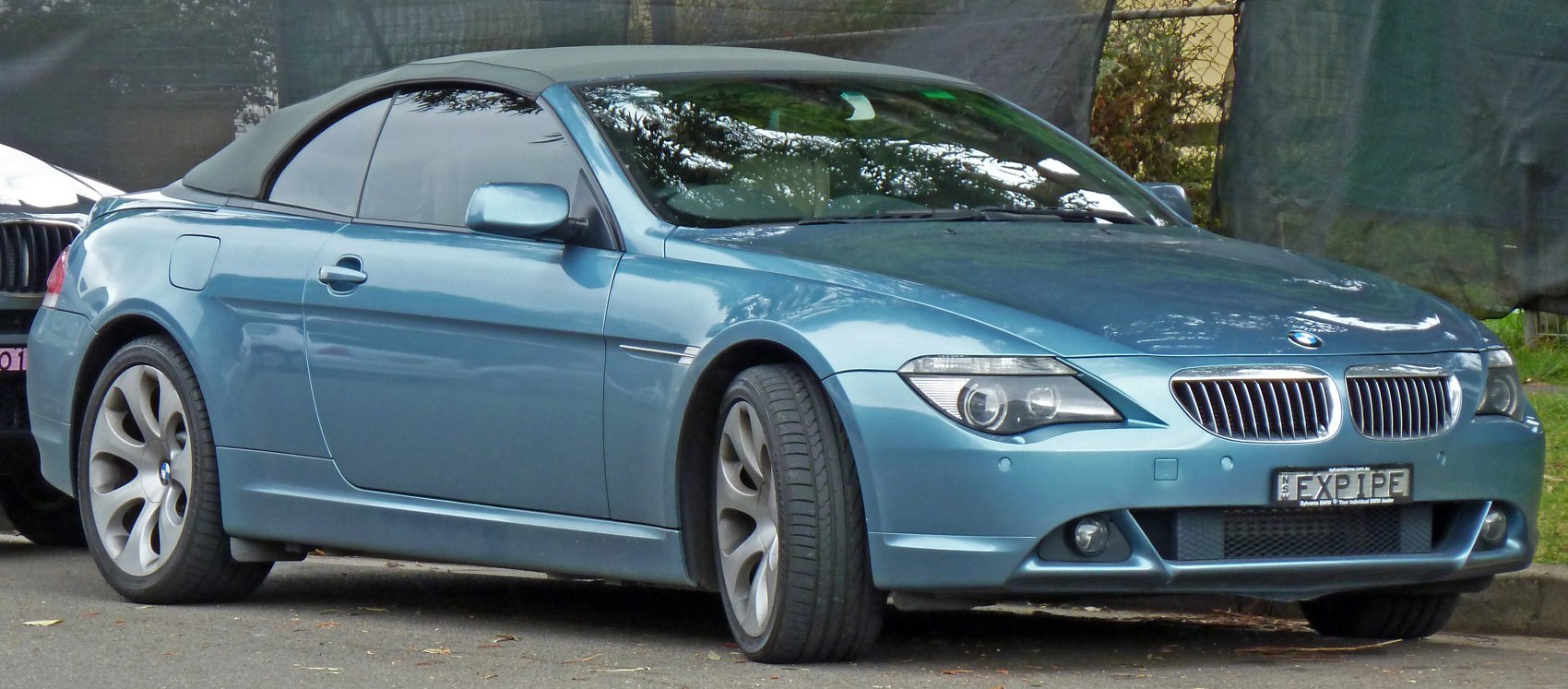 Front side view of a convertible with soft top and alloy wheels