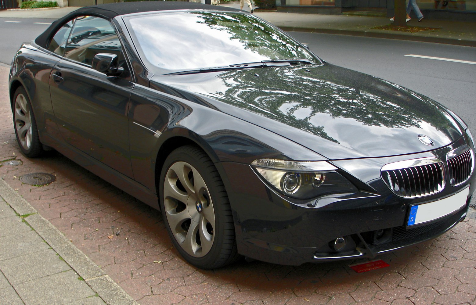 Front-side view of convertible with soft top and distinct headlights