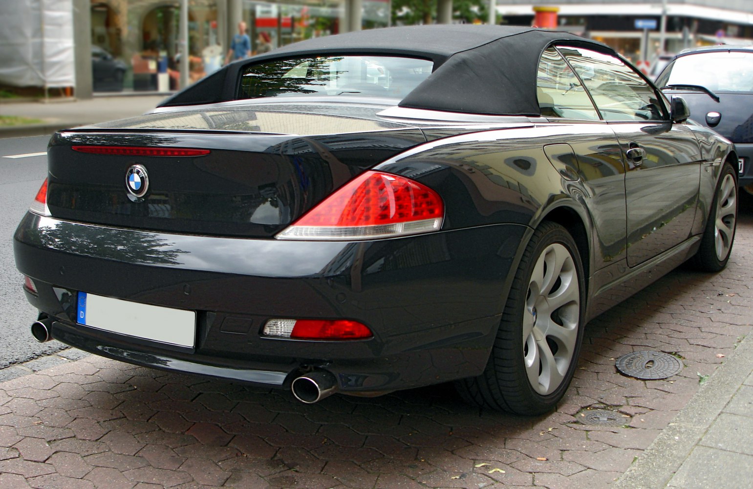 Rear view of a convertible with soft top and dual exhausts