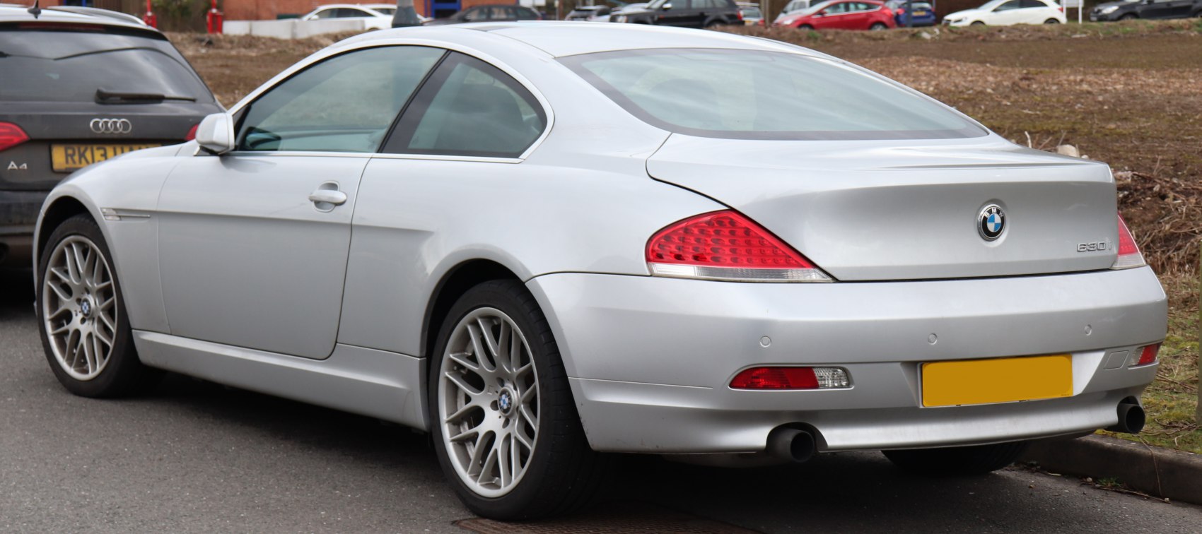 Silver 2-door coupe with sporty wheels and distinct rear lights.