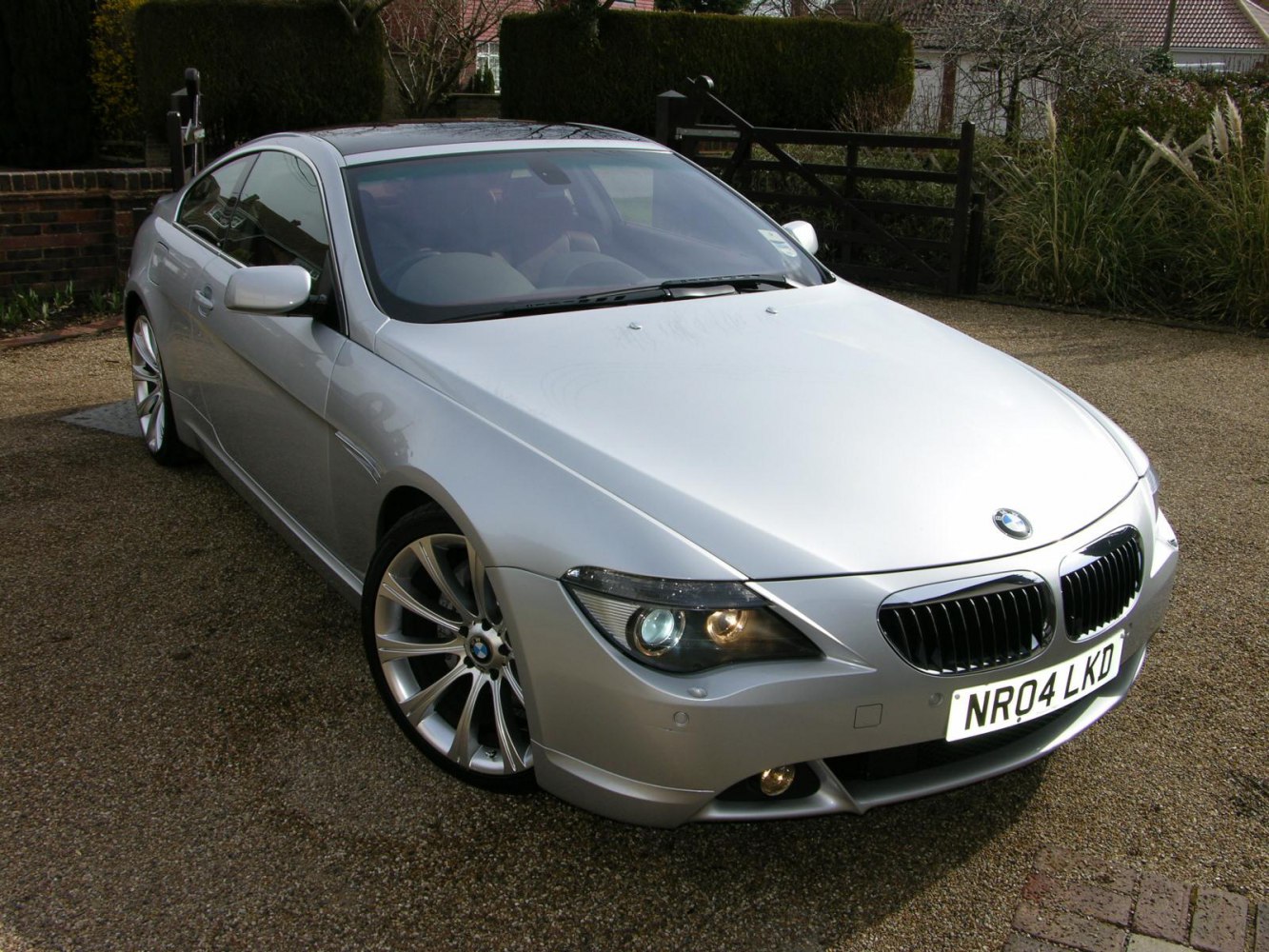 Front view of silver coupe with kidney grille and alloy wheels