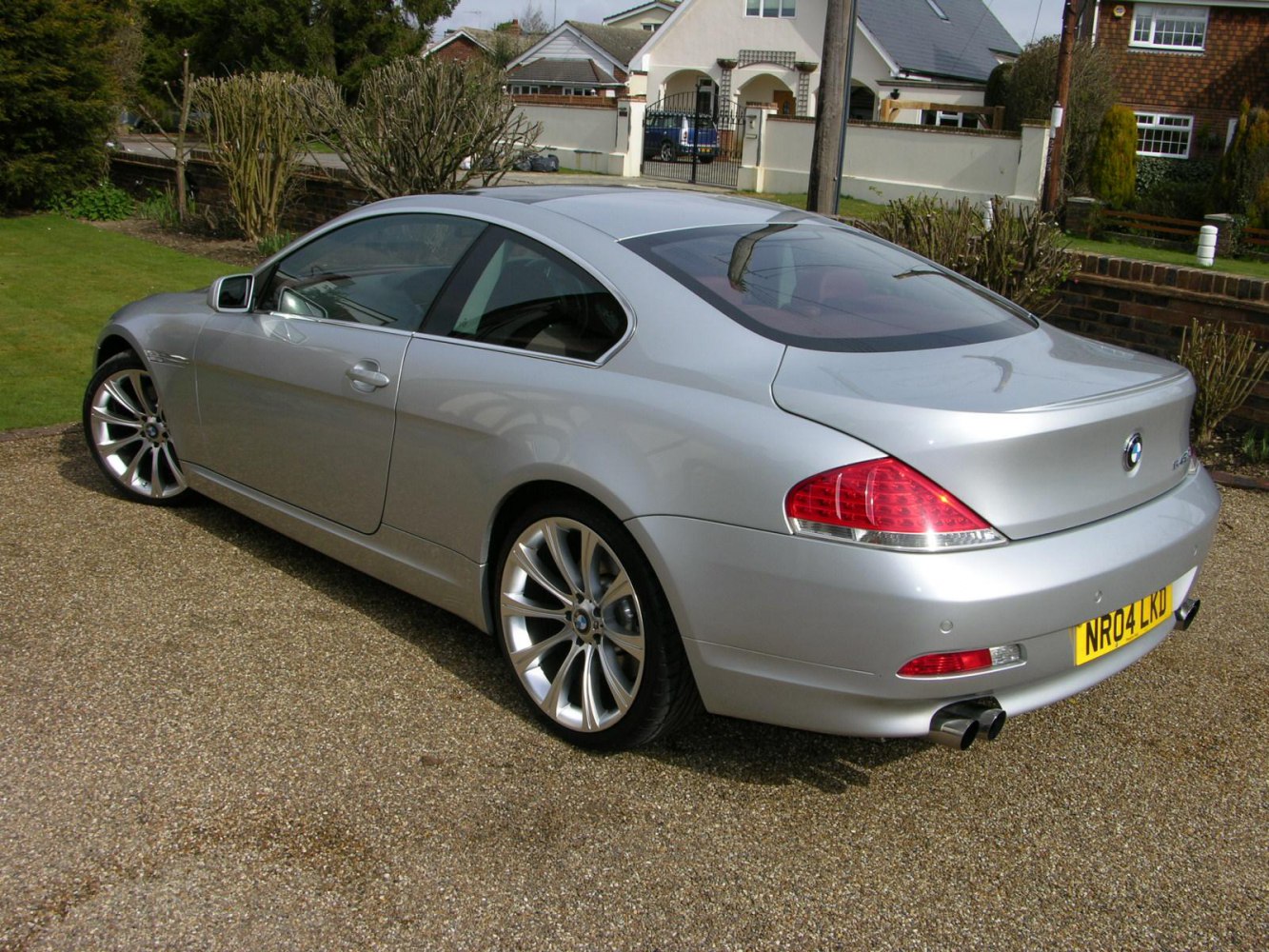 Silver coupe rear and side view with alloy wheels and dual exhaust.
