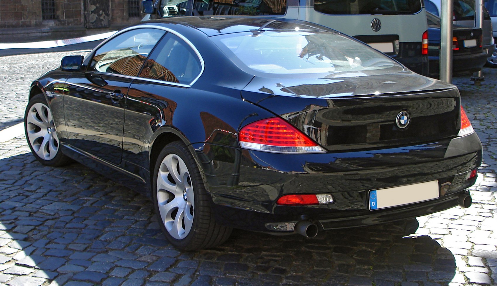 Rear view of luxury coupe with distinctive taillights and dual exhausts