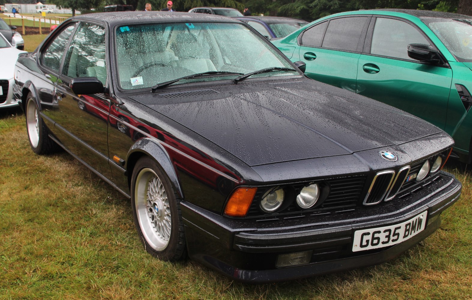 Front view of classic BMW with quad round headlights and iconic grille.