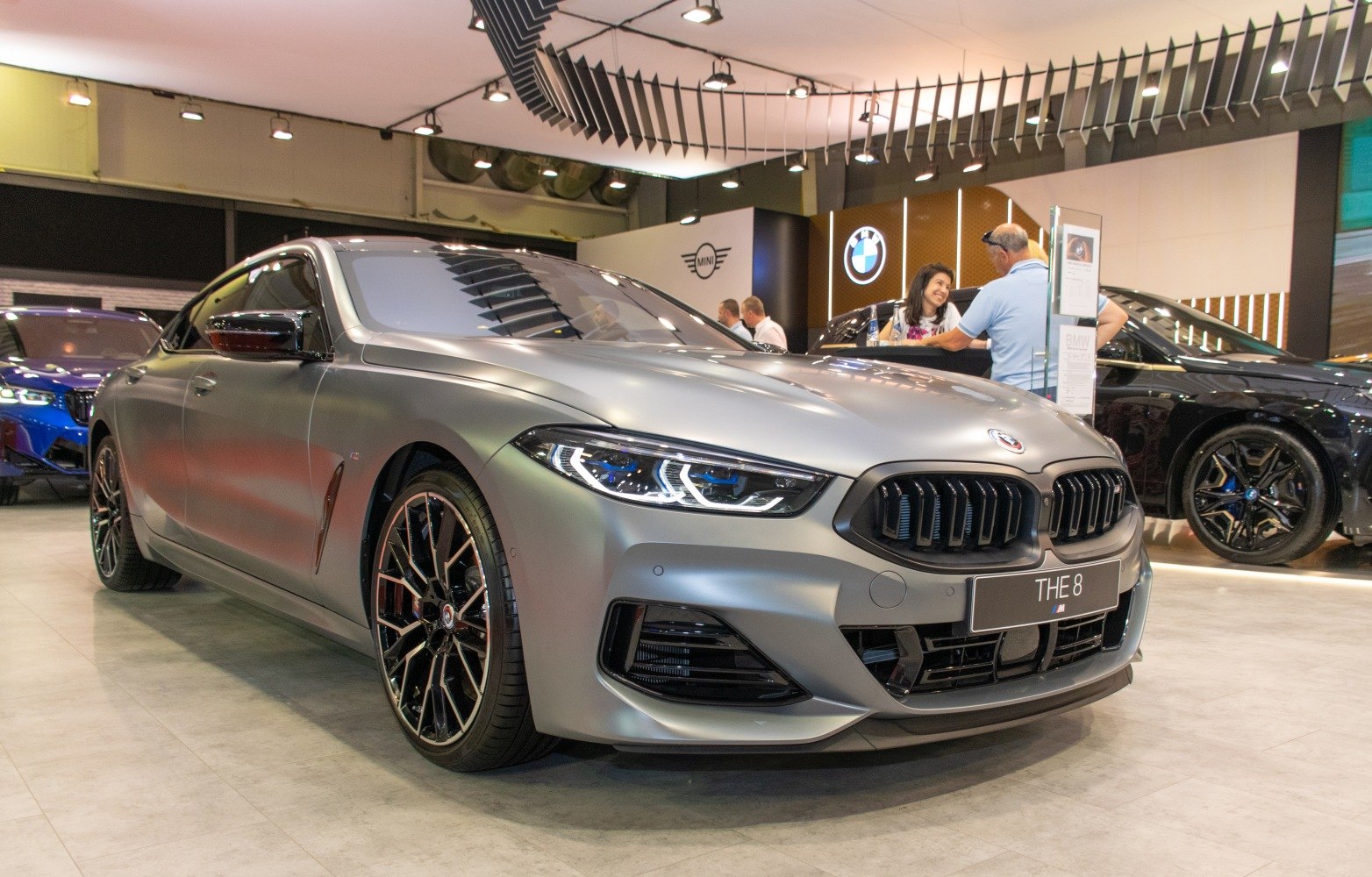 Front view of sleek luxury sedan with aggressive grille and multi-spoke black alloy wheels