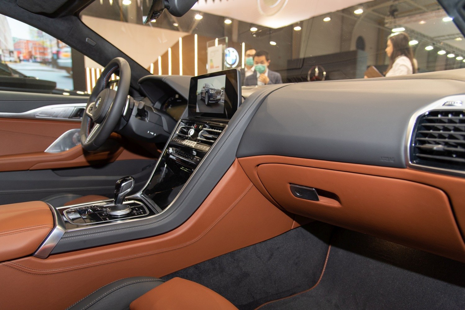 Luxury car interior with dashboard, infotainment screen, and leather upholstery