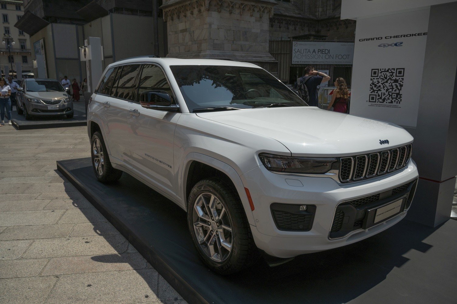 White SUV with distinctive grille, LED headlights, and alloy wheels displayed outdoors.
