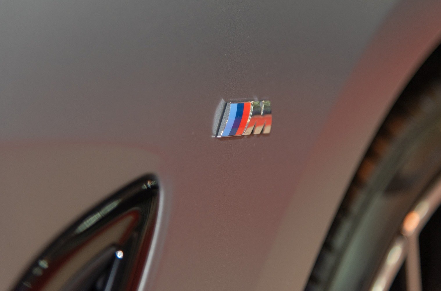 Close-up of BMW M performance badge on car body