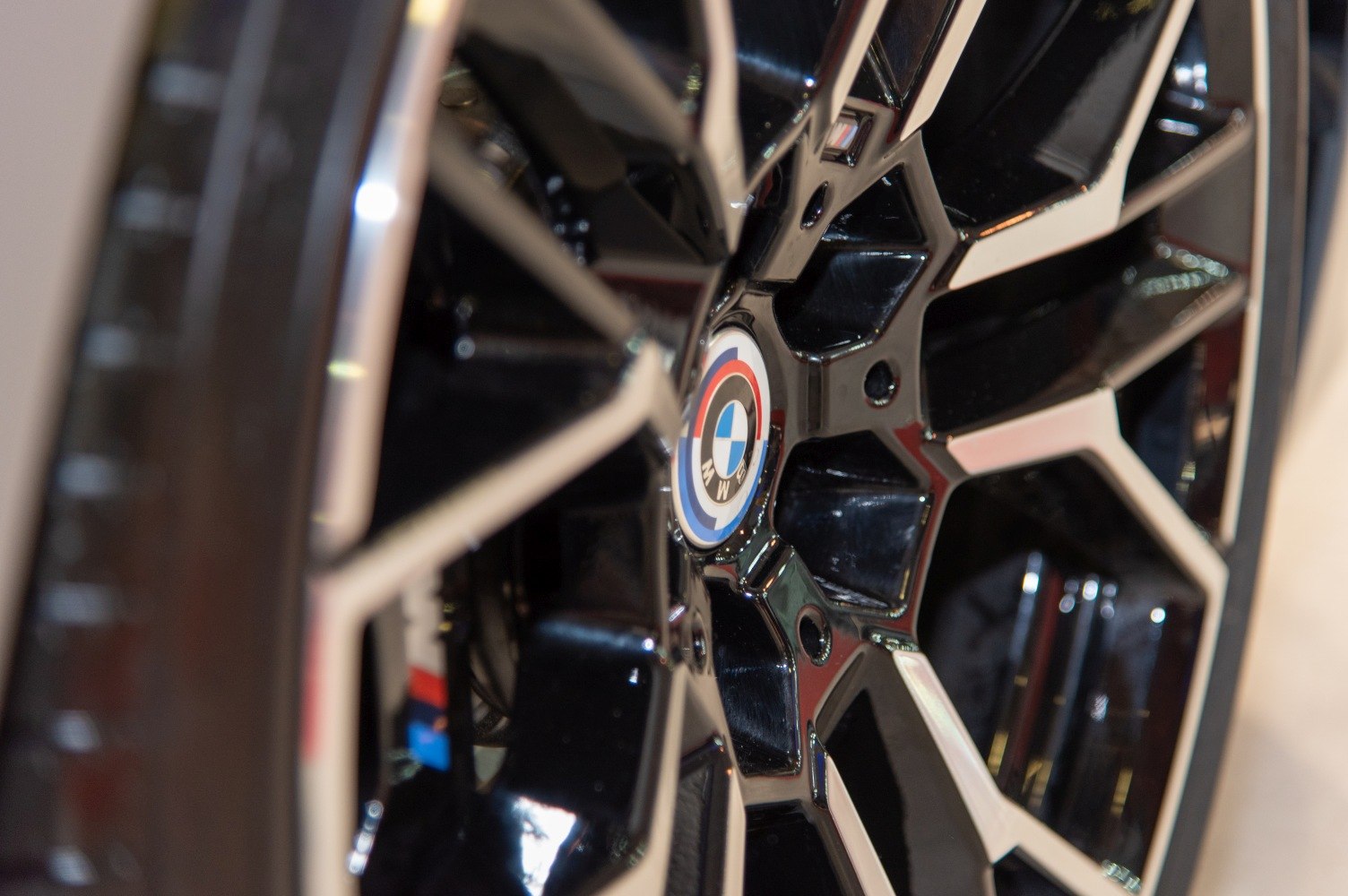 Glossy black and silver multi-spoke alloy wheel with BMW center cap