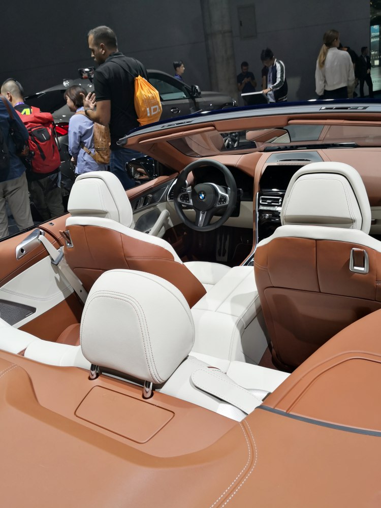 Dual-tone leather seats and modern dashboard of a luxurious convertible