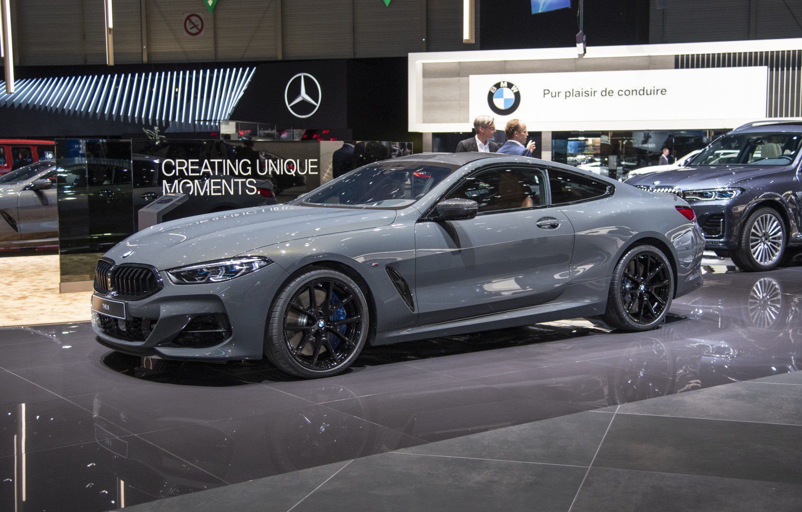 Glossy gray coupe with black sporty wheels and sharp aerodynamics