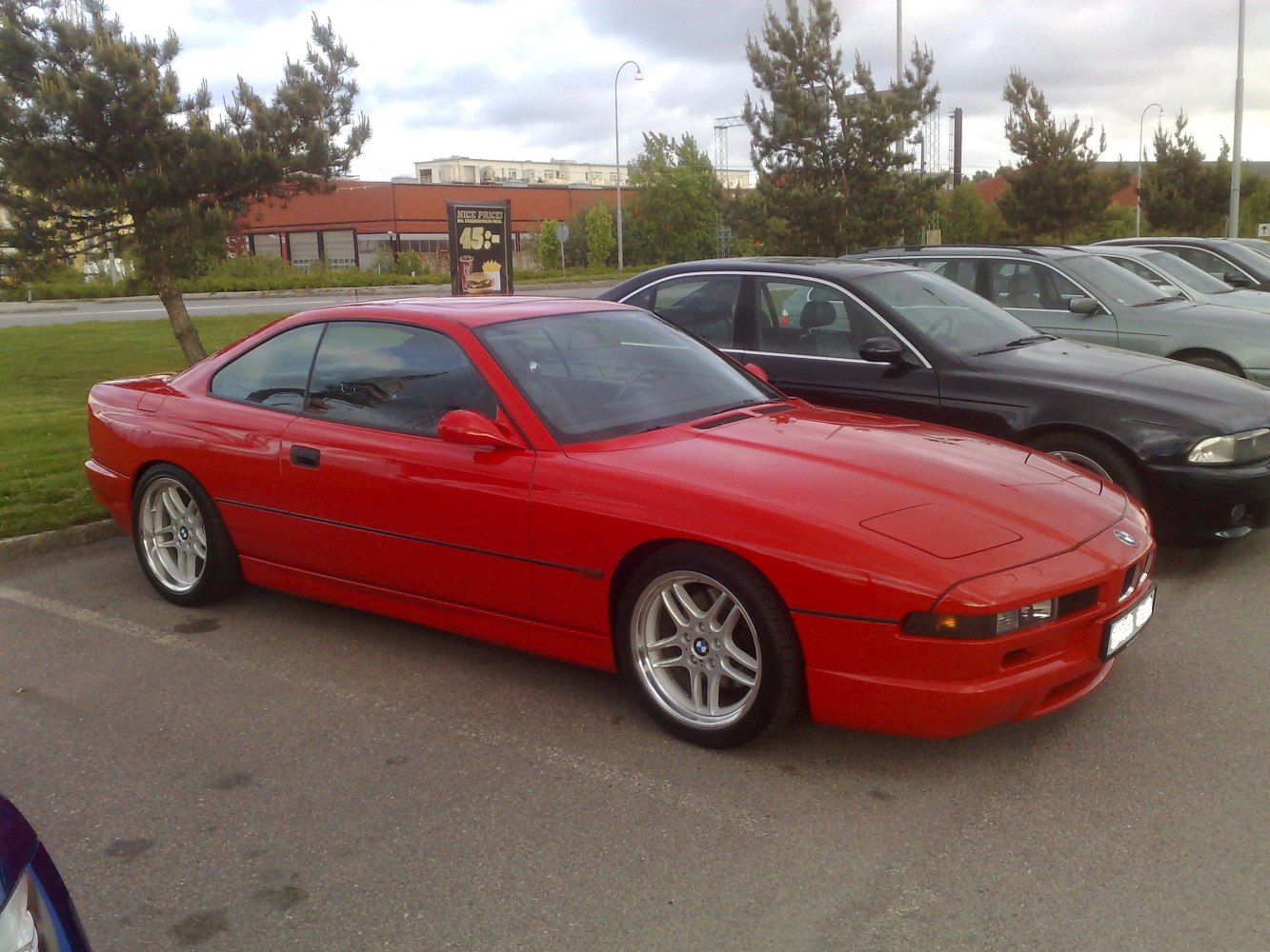 Red sports coupe with pop-up headlights and silver alloy wheels