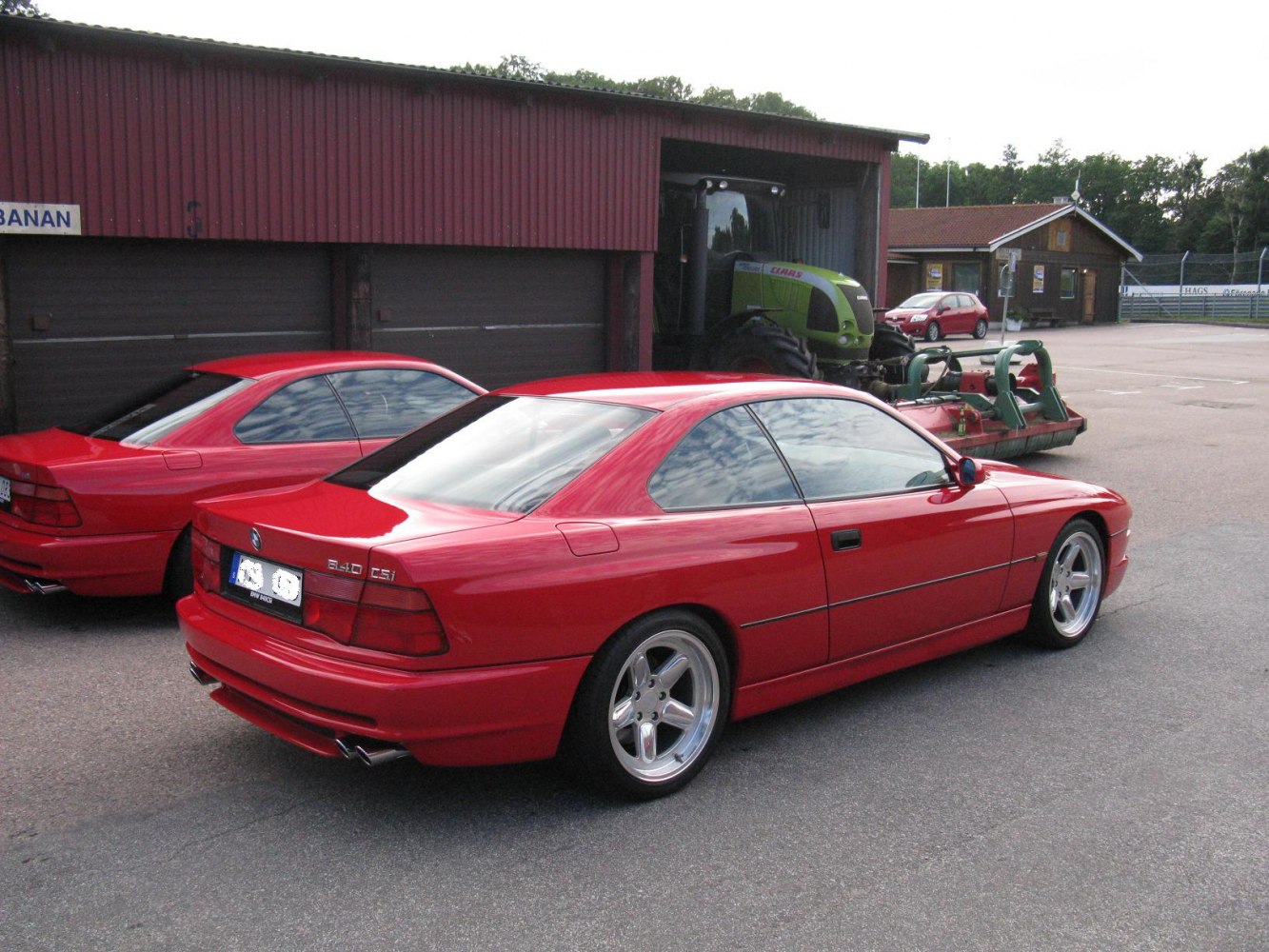 Red BMW coupe rear and side with alloy wheels