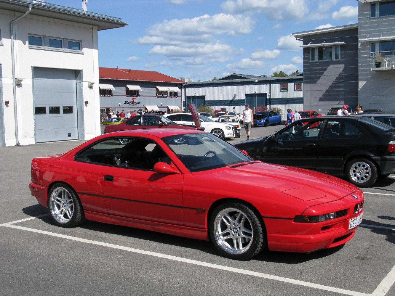 Red coupe with pop-up headlights and sleek aerodynamic design.