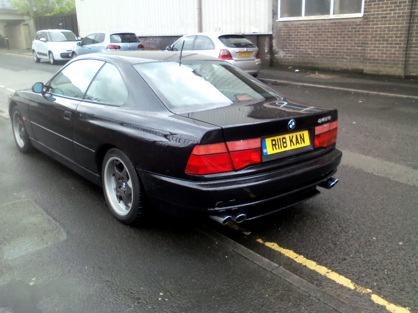 Rear view of a coupe with dual exhaust and distinctive taillights