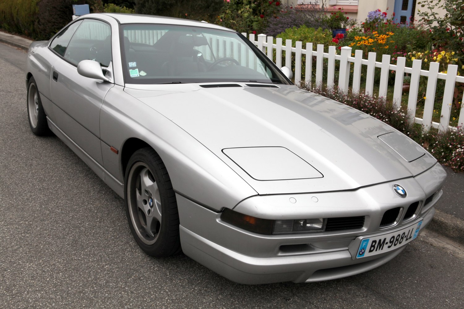 Silver coupe with pop-up headlights and classic alloy wheels