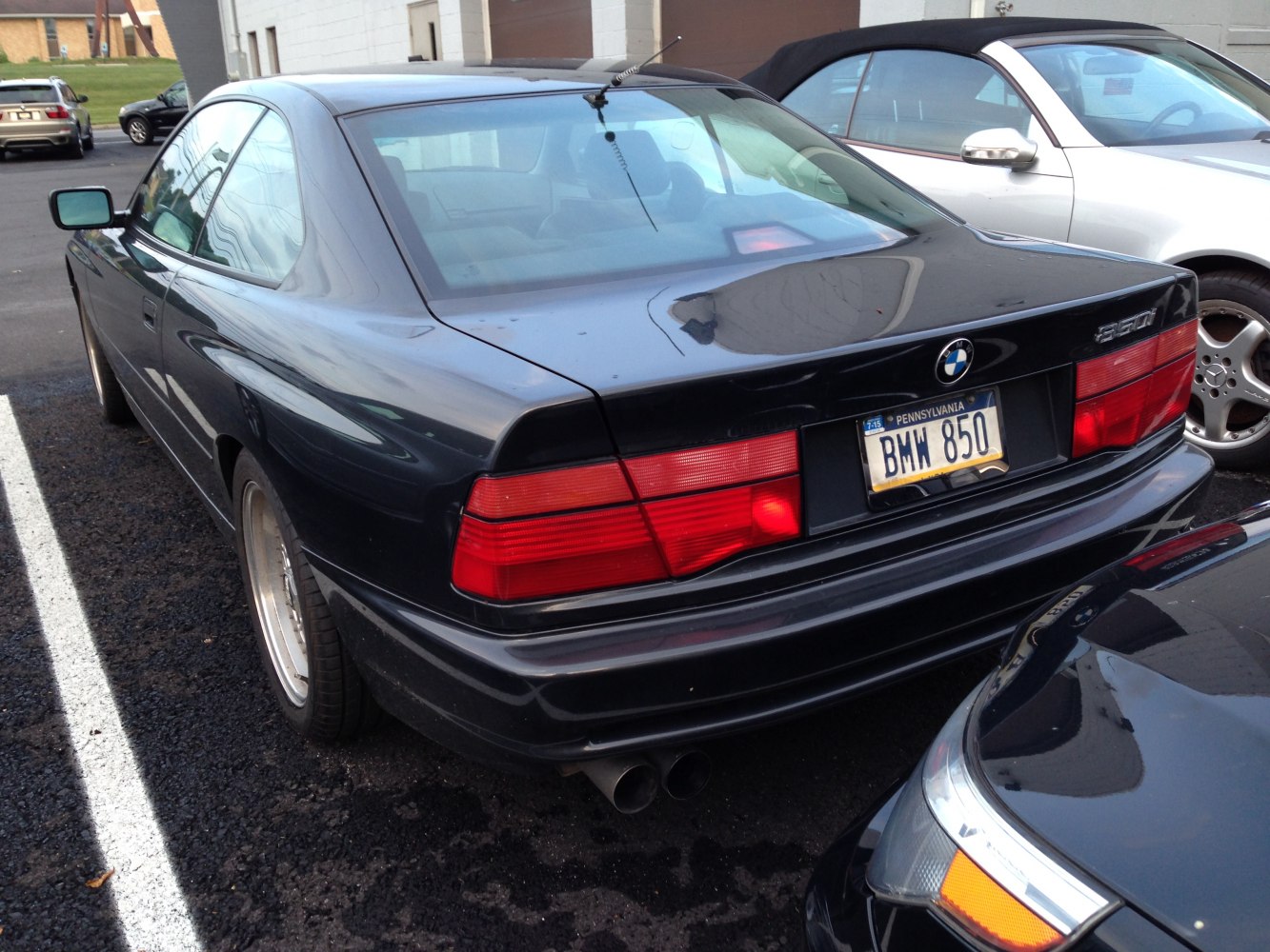 Rear view of classic coupe with dual exhaust and wide tail lights