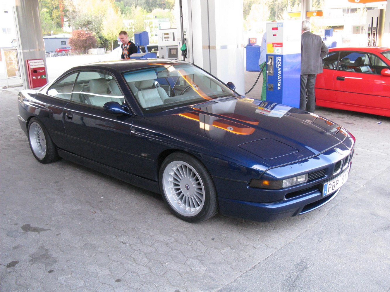 Sleek two-door coupe with pop-up headlights and multi-spoke rims