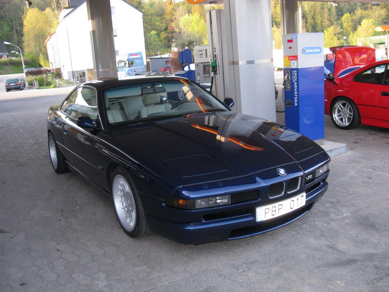 Sleek sport coupe with pop-up headlights and a V12 badge.