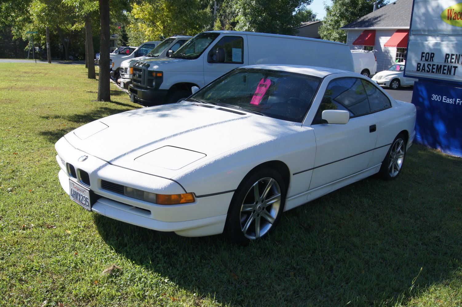 White coupe with pop-up headlights and sleek design