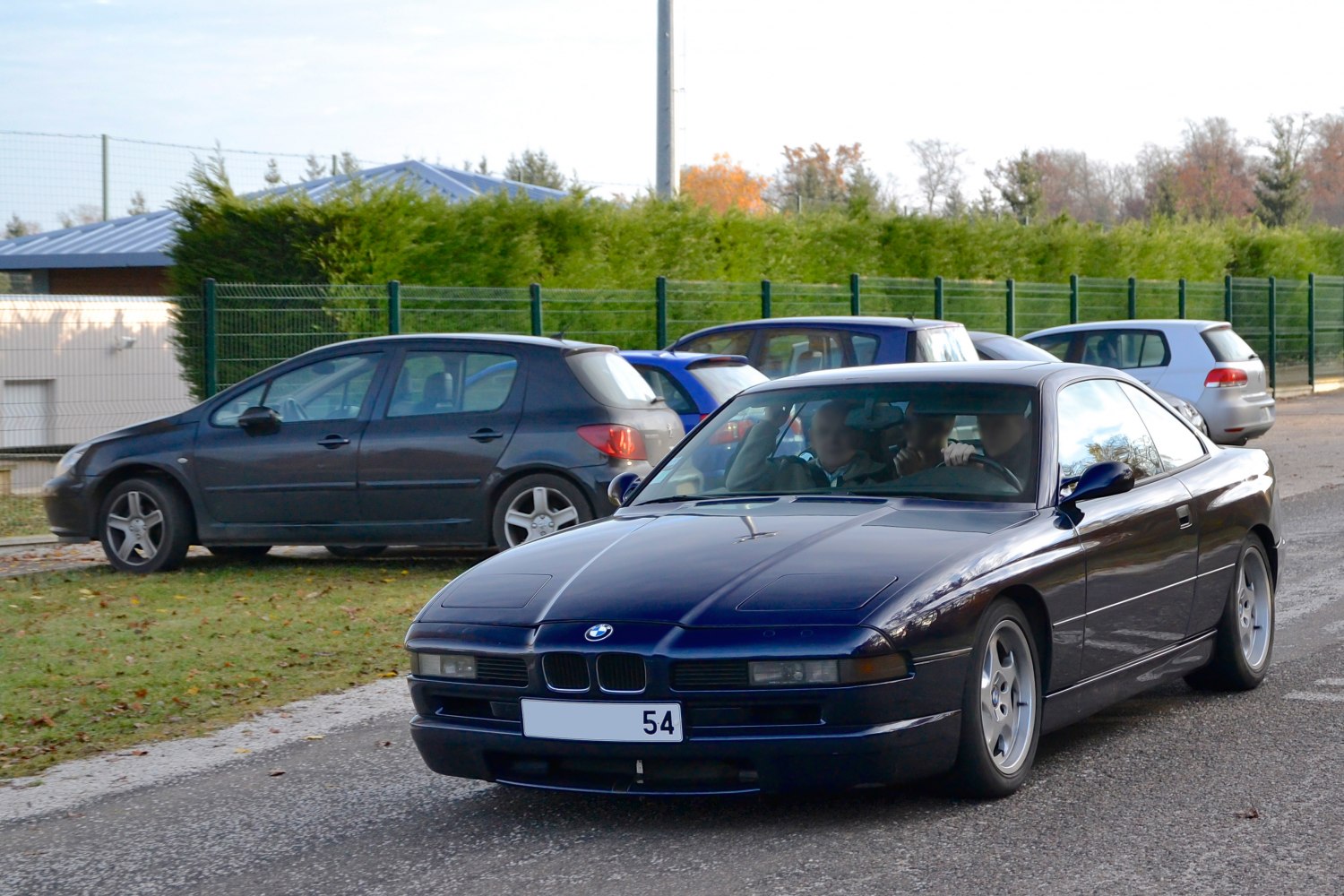 Sleek coupe front view with pop-up headlights and kidney grille