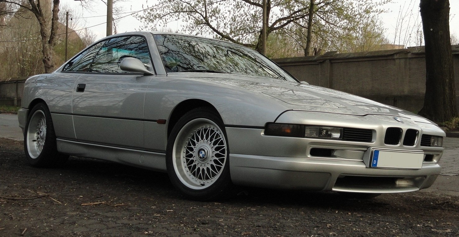 Silver classic coupe with pop-up headlights and multi-spoke alloy wheels