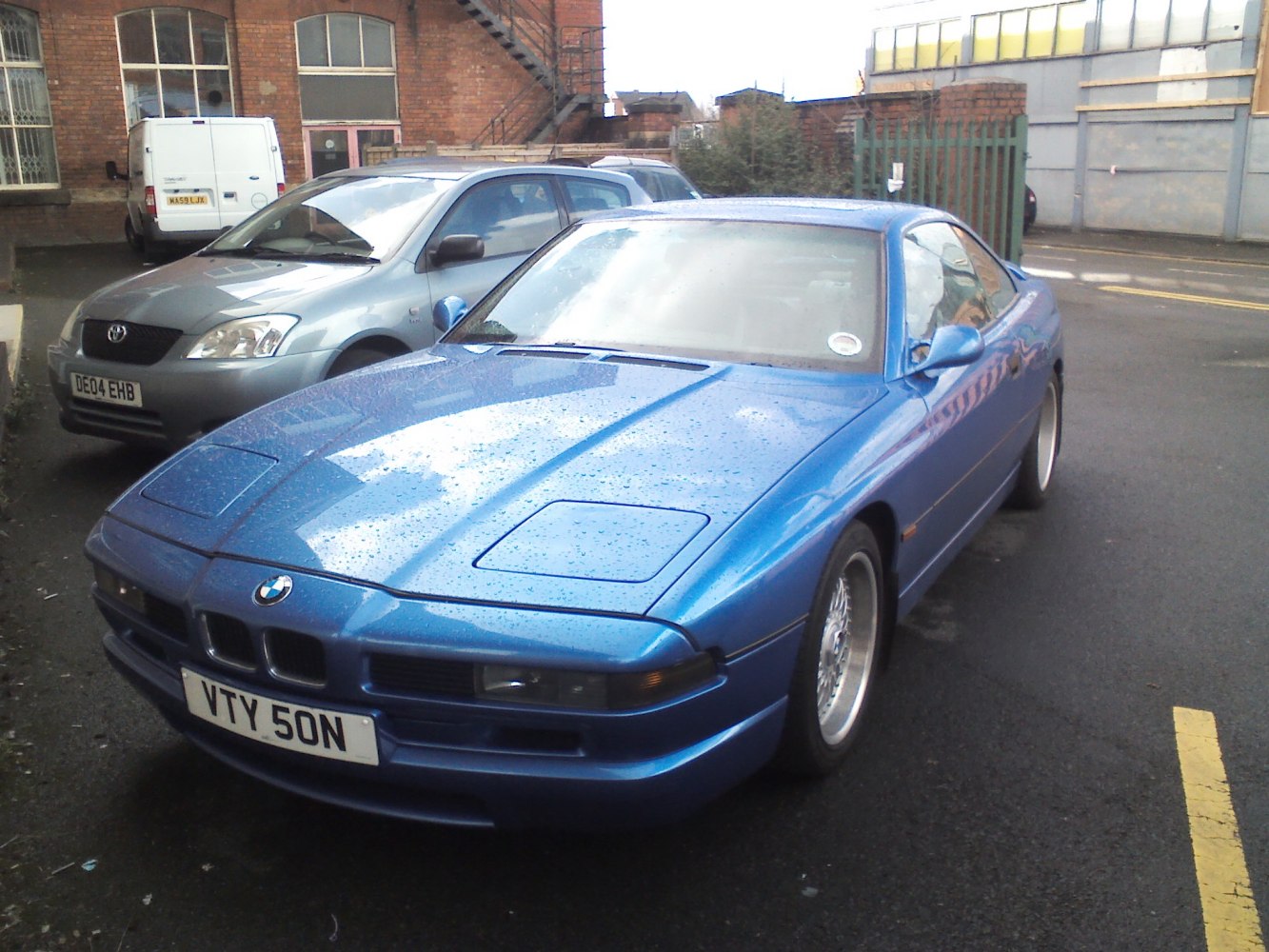 Blue coupe with pop-up headlights and kidney grille