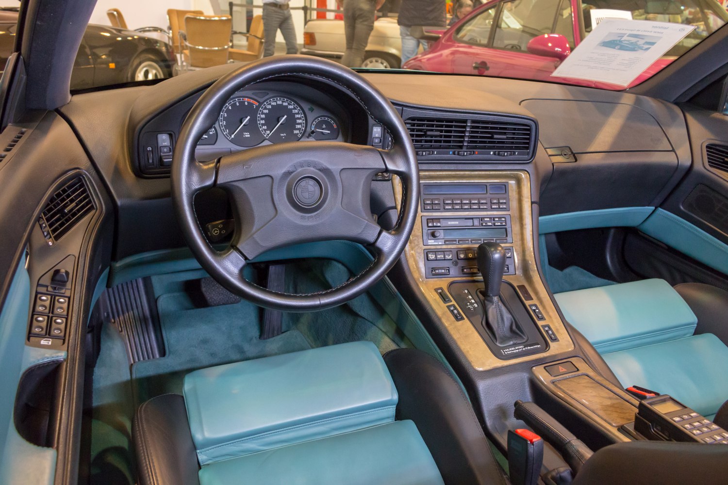 Classic car interior with dashboard, steering wheel, and center console