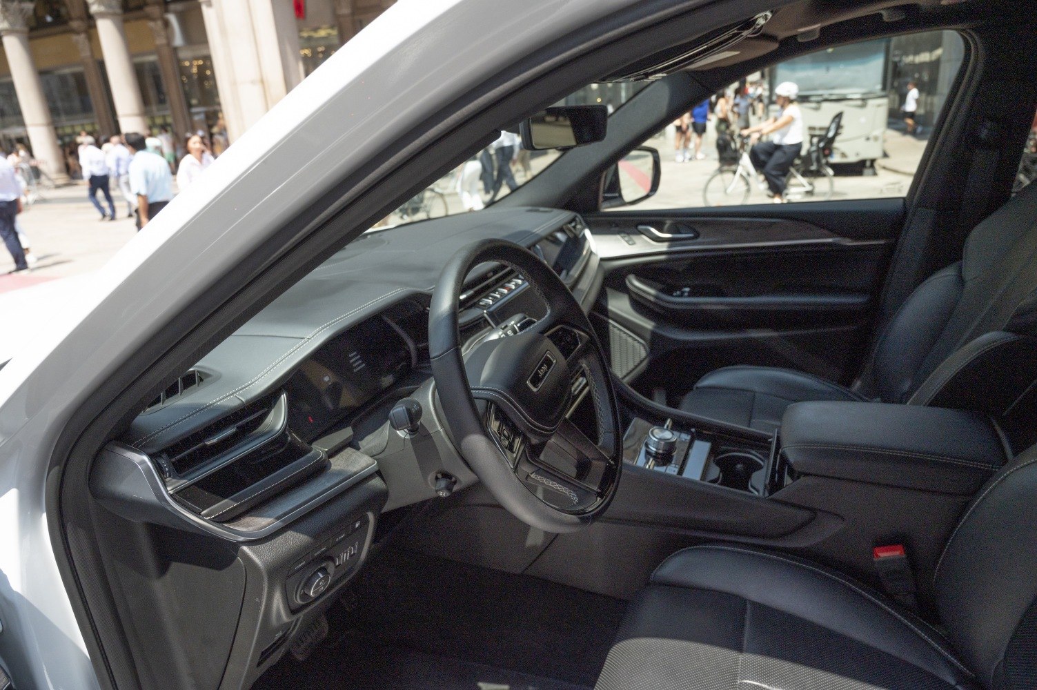 Modern car interior dashboard and steering wheel with center console.