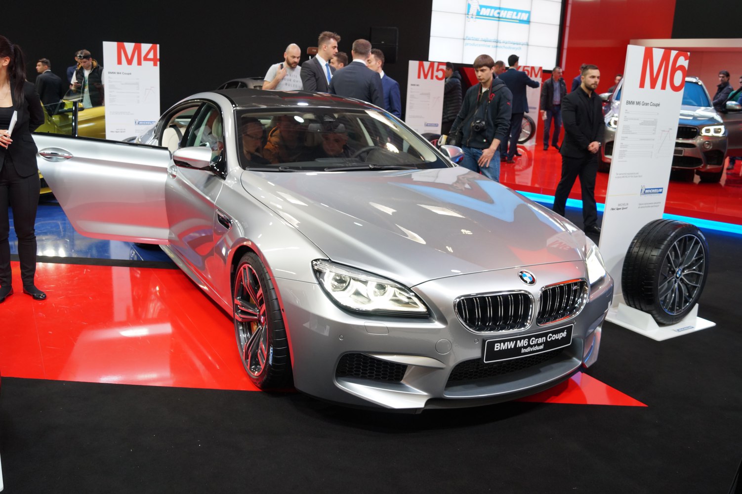 Silver luxury coupe with prominent front headlights and alloy wheels
