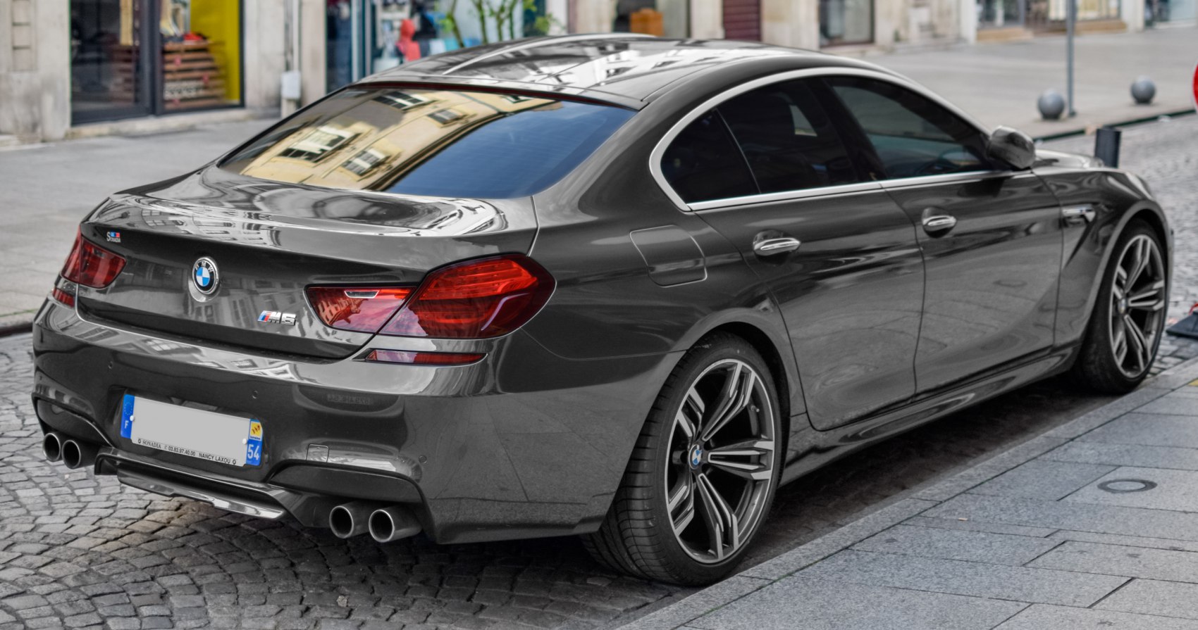Rear view with quad exhausts, sporty alloy wheels, and distinct taillights