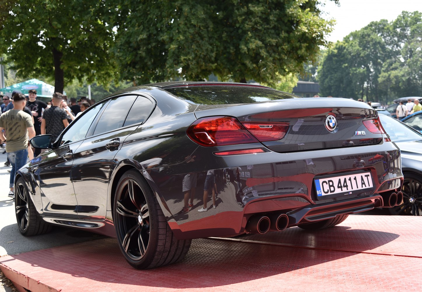 Rear view of a luxury sport sedan with quad exhausts and sleek taillights