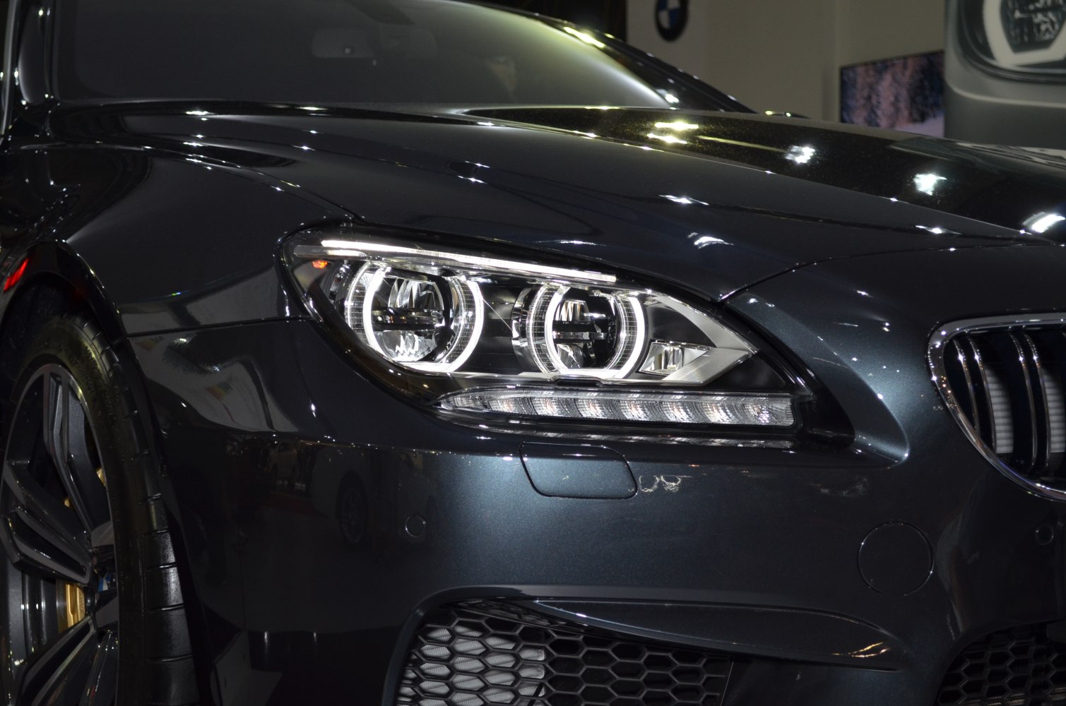 Close-up of front headlight and grille with LED lighting and aggressive styling