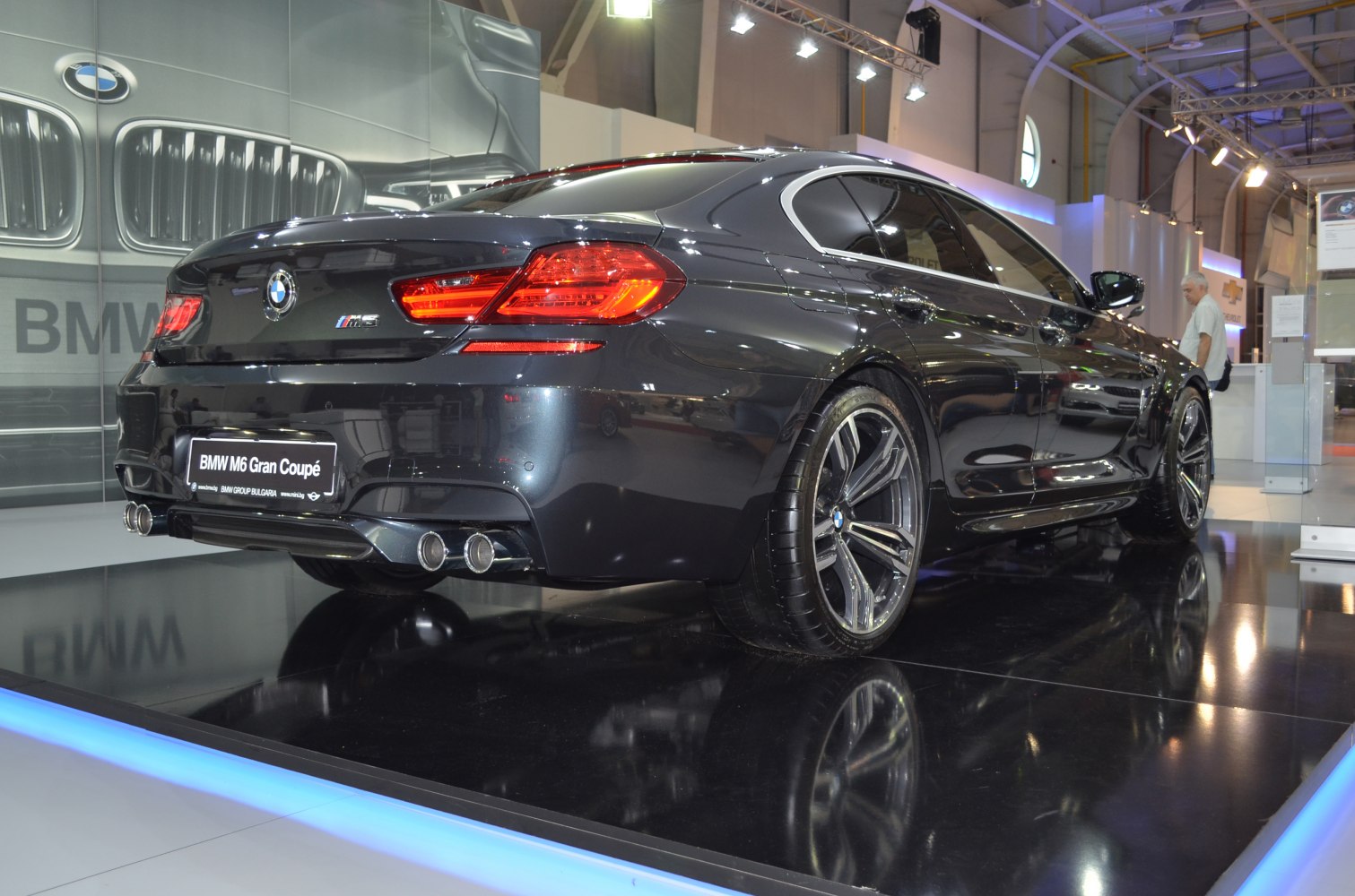 Rear view of a luxury sedan with quad exhaust and signature taillights