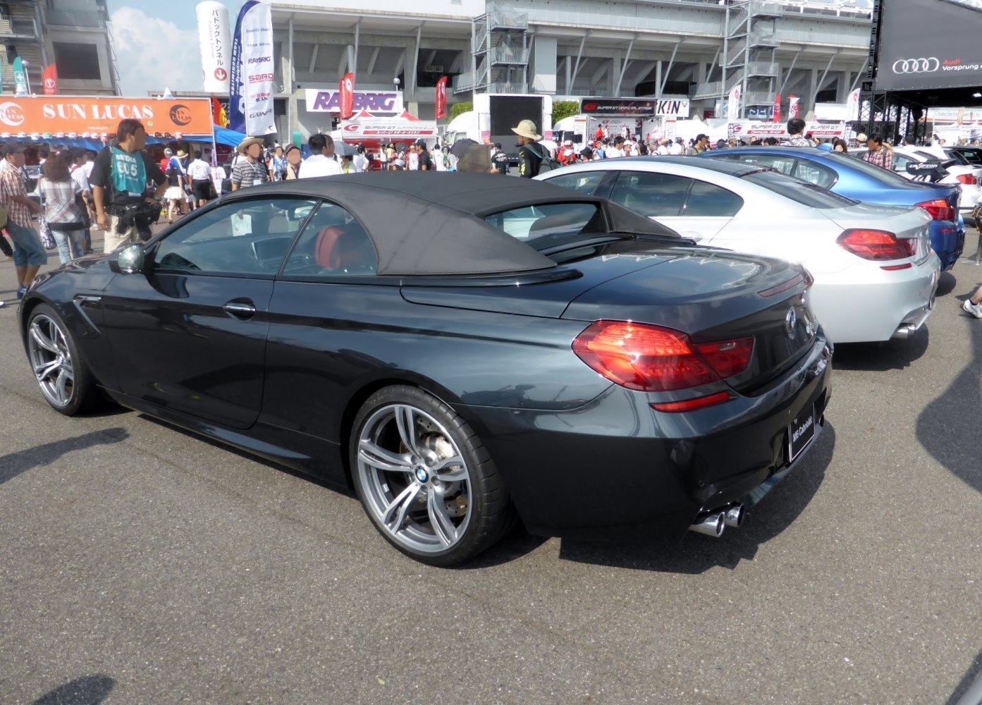 Convertible BMW with soft top, rear lights, and alloy wheels