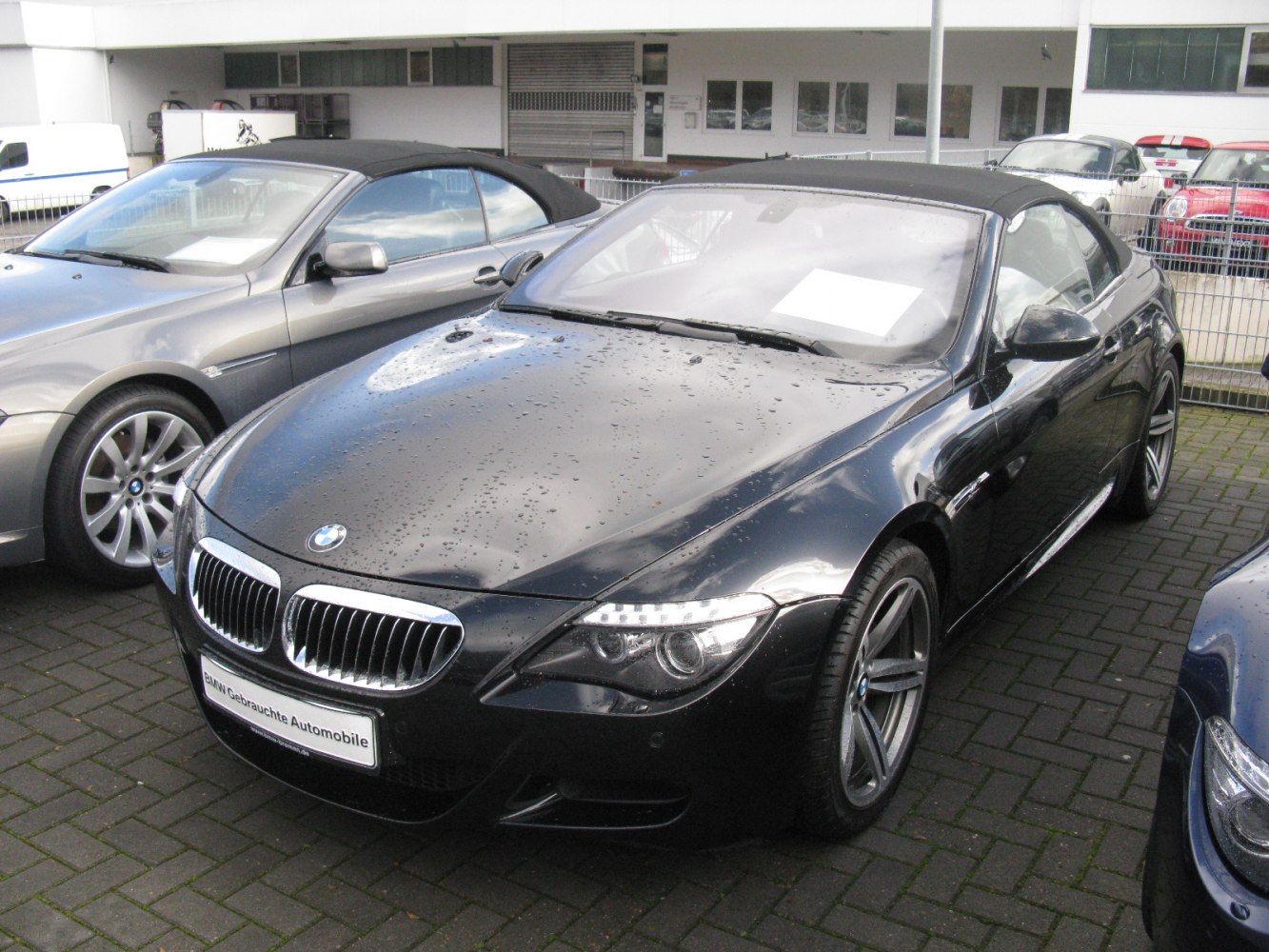 Black convertible with kidney grille and LED headlights under closed soft top