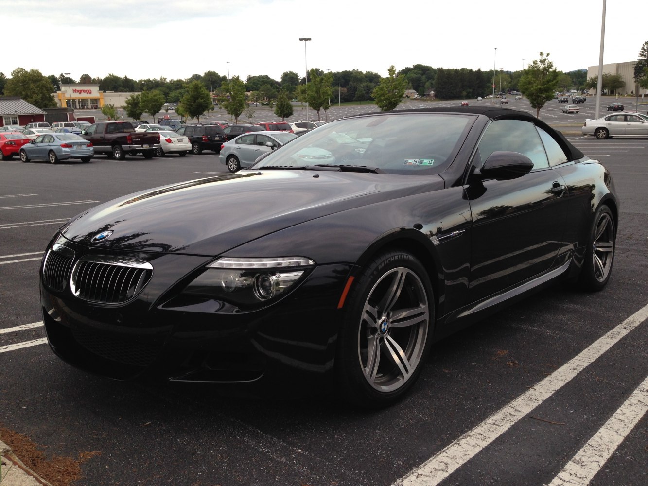 Black soft-top convertible with sharp front and alloy wheels